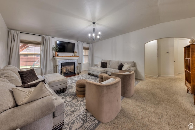 558 Winesap Cir, Moab, UT 84532 - carpeted living room with arched walkways, a chandelier, plenty of natural light, and a tile fireplace