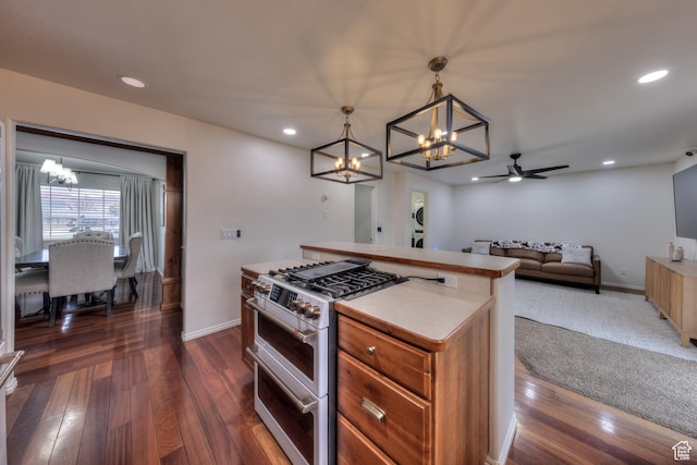 558 Winesap Cir, Moab, UT 84532 - kitchen featuring a chandelier, range with two ovens, ceiling fan, dark wood-style floors, and open floor plan