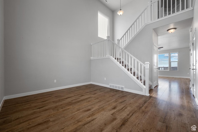 248 W Quartz Rd, Tooele, UT 84074 - unfurnished living room with stairway, baseboards, and wood finished floors