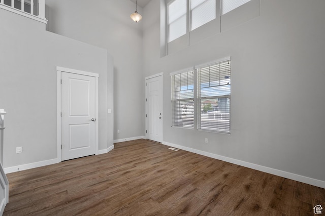 248 W Quartz Rd, Tooele, UT 84074 - foyer entrance with plenty of natural light, a towering ceiling, wood finished floors, and baseboards