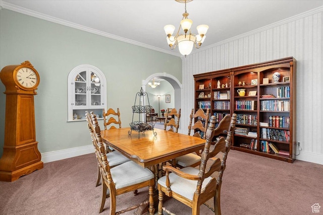 carpeted dining space with a notable chandelier and ornamental molding