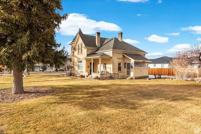 back of house with a lawn