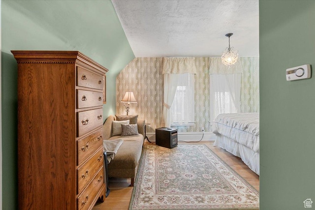 bedroom featuring light wood-type flooring and a textured ceiling
