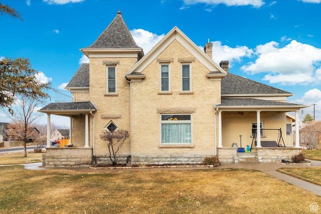 view of front of home featuring covered porch and a front yard