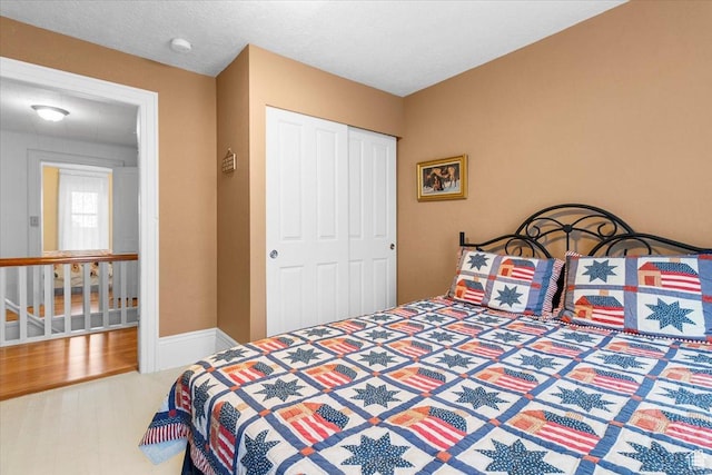 bedroom with hardwood / wood-style floors and a closet