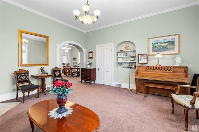 sitting room featuring carpet flooring, built in shelves, crown molding, and an inviting chandelier
