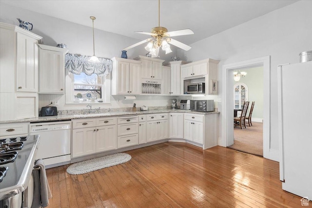 kitchen featuring white cabinetry, ceiling fan with notable chandelier, light hardwood / wood-style floors, and white appliances