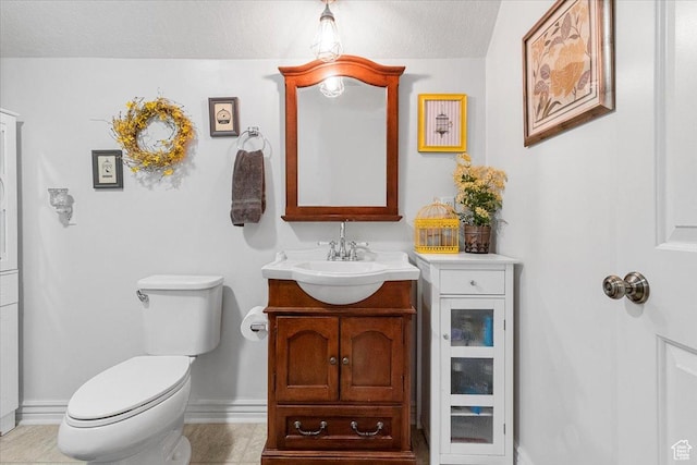 bathroom with vanity, tile patterned floors, a textured ceiling, and toilet