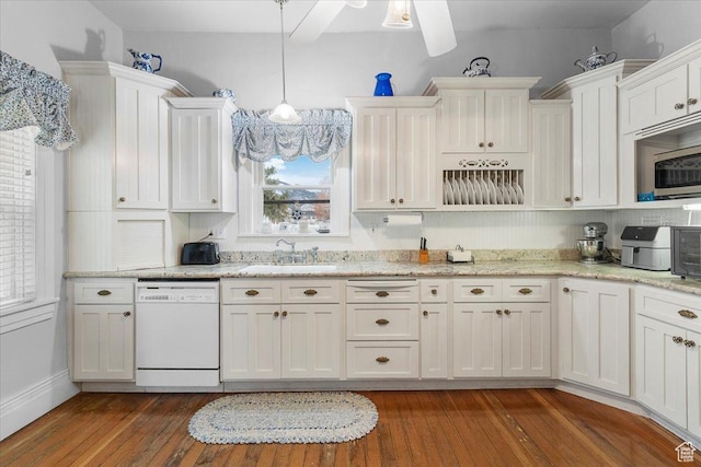kitchen with sink, white dishwasher, a healthy amount of sunlight, and decorative light fixtures