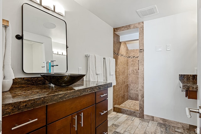 561 S Vasels Rd Unit R16-C, Brian Head, UT 84719 - full bathroom featuring vanity, baseboards, visible vents, wood tiled floor, and walk in shower