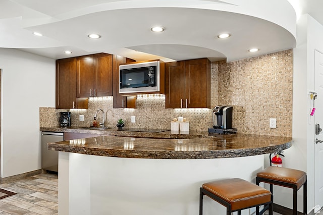 561 S Vasels Rd Unit R16-C, Brian Head, UT 84719 - kitchen featuring decorative backsplash, a sink, built in microwave, light wood-style floors, and stainless steel dishwasher