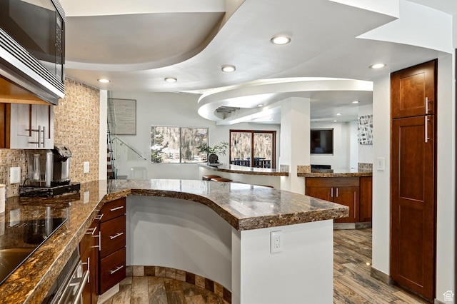 561 S Vasels Rd Unit R16-C, Brian Head, UT 84719 - kitchen featuring black electric cooktop, recessed lighting, a peninsula, built in microwave, and tasteful backsplash