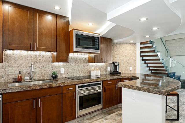 561 S Vasels Rd Unit R16-C, Brian Head, UT 84719 - kitchen with a peninsula, black electric stovetop, built in microwave, stainless steel oven, and a sink
