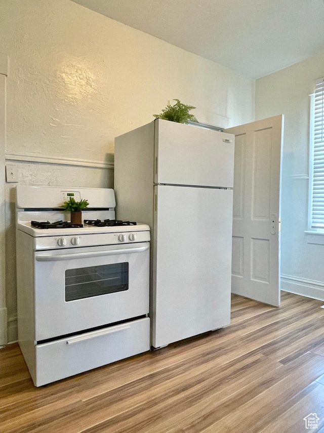 2353 Harrison Blvd, Ogden, UT 84401 - kitchen with white appliances and light hardwood / wood-style flooring