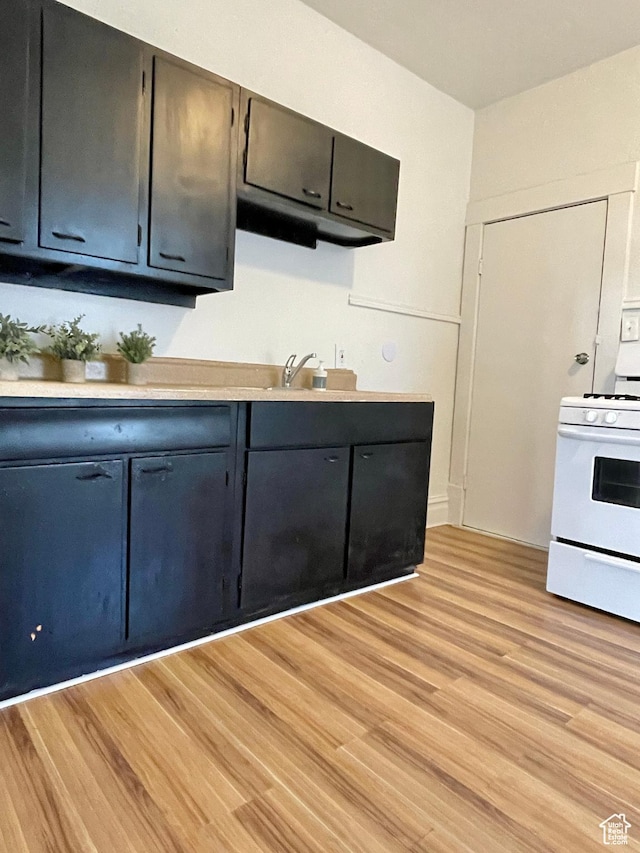 2353 Harrison Blvd, Ogden, UT 84401 - kitchen featuring white range with electric stovetop, light hardwood / wood-style flooring, and sink