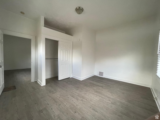 2433 Monroe Blvd, Ogden, UT 84401 - unfurnished bedroom with a closet, dark wood-style flooring, visible vents, and baseboards