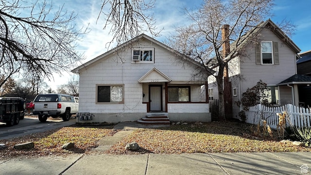 bungalow-style house with fence