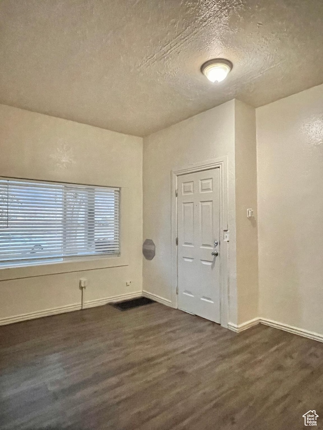 2433 Monroe Blvd, Ogden, UT 84401 - interior space with a textured ceiling, baseboards, and dark wood-style flooring