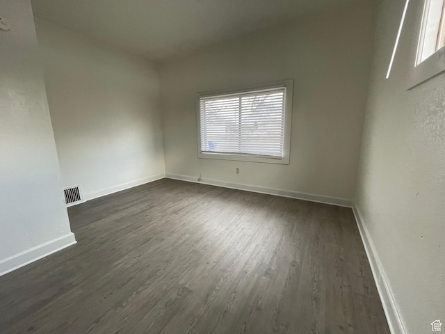 2433 Monroe Blvd, Ogden, UT 84401 - spare room with baseboards, visible vents, and dark wood-type flooring