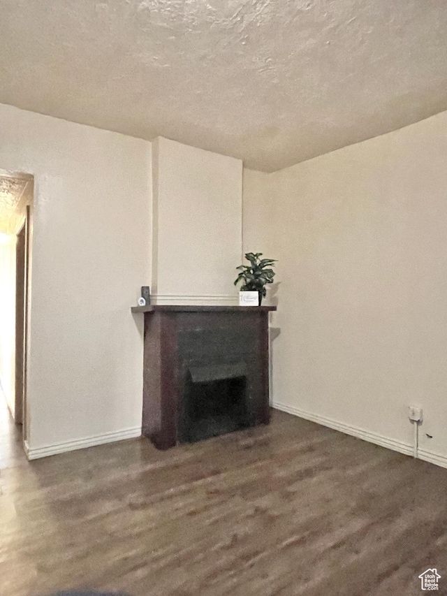 2433 Monroe Blvd, Ogden, UT 84401 - unfurnished living room featuring a fireplace, baseboards, and wood finished floors