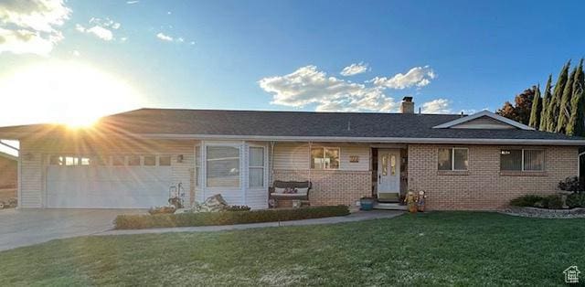 ranch-style home with a front lawn and a garage
