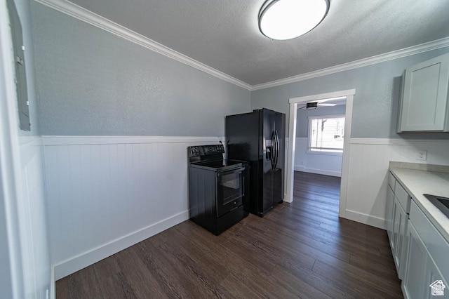 kitchen featuring a textured ceiling, dark wood-type flooring, crown molding, black appliances, and white cabinets