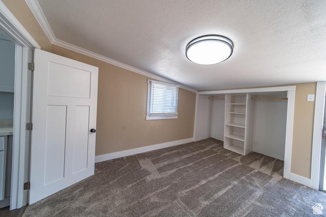 unfurnished bedroom featuring crown molding, a closet, dark carpet, and a textured ceiling