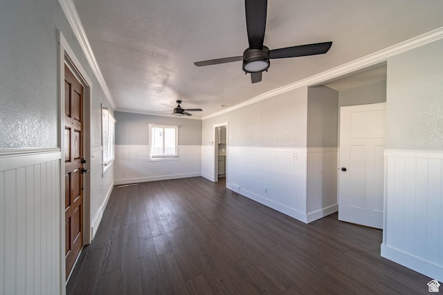 spare room featuring dark hardwood / wood-style flooring, ceiling fan, and ornamental molding