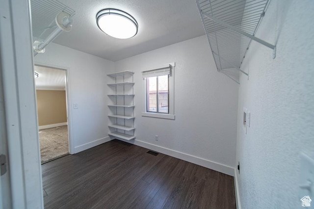 walk in closet featuring dark wood-type flooring