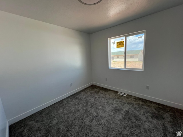1241 N 3500 E, Ballard, UT 84066 - empty room featuring baseboards, dark colored carpet, a textured ceiling, and visible vents