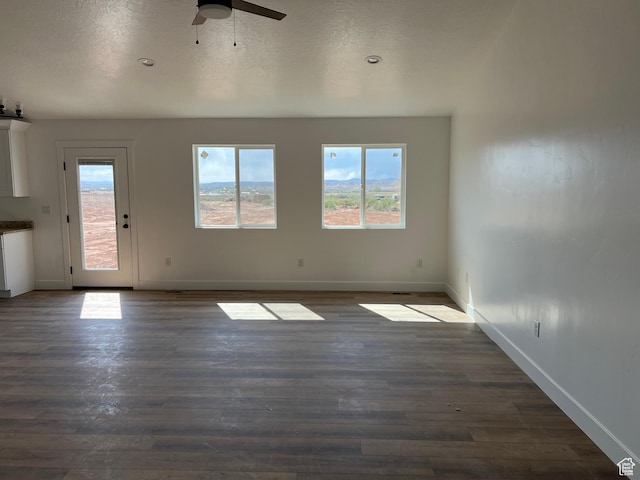 1241 N 3500 E, Ballard, UT 84066 - unfurnished living room with baseboards, a ceiling fan, dark wood-type flooring, and a textured ceiling