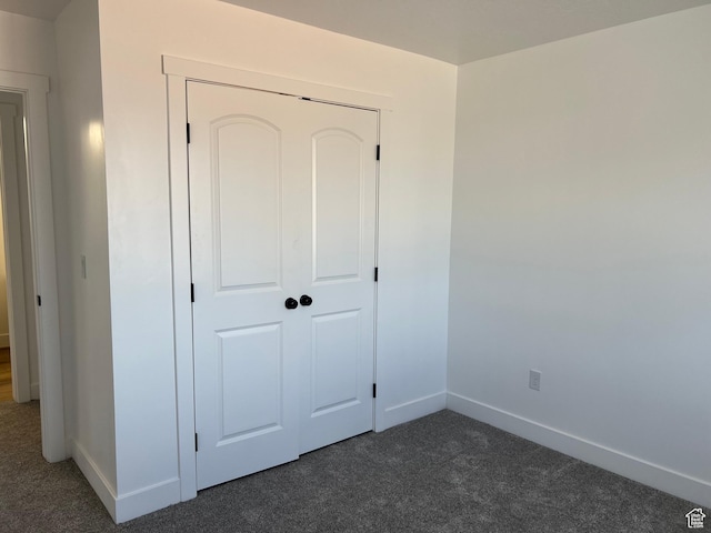 1241 N 3500 E, Ballard, UT 84066 - unfurnished bedroom with baseboards, dark carpet, and a closet