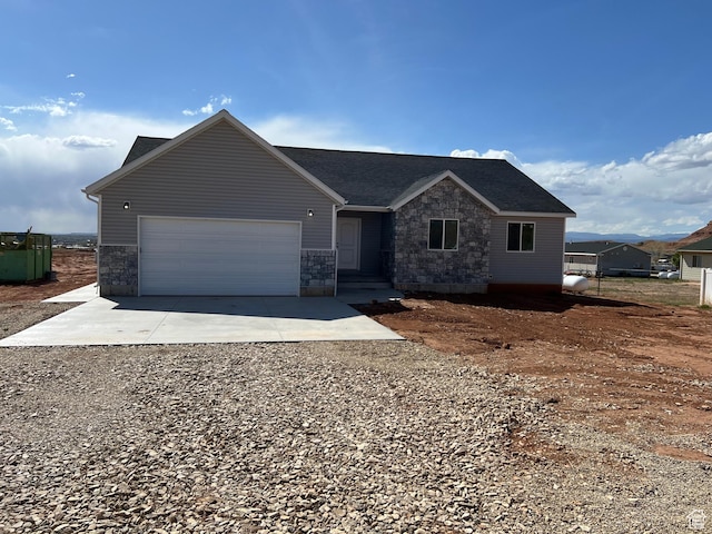 1241 N 3500 E, Ballard, UT 84066 - single story home with an attached garage, driveway, stone siding, and a shingled roof