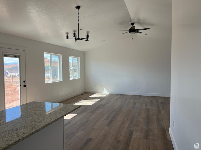 1241 N 3500 E, Ballard, UT 84066 - unfurnished dining area featuring ceiling fan with notable chandelier, baseboards, dark wood-type flooring, and lofted ceiling