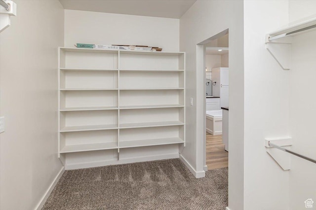 spacious closet featuring dark carpet