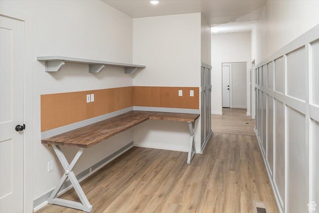 unfurnished office with light hardwood / wood-style flooring