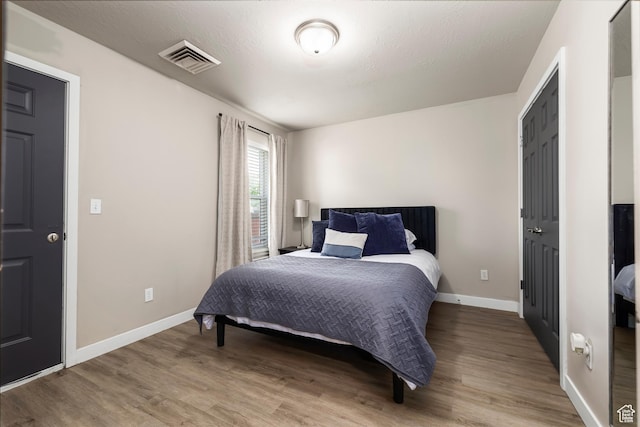 159 E 800 S Unit 208, Salt Lake City, UT 84111 - bedroom with wood-type flooring and a textured ceiling