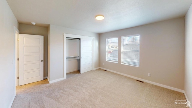 633 W Junegrass Ln, Stansbury Park, UT 84074 - unfurnished bedroom featuring light colored carpet and a closet