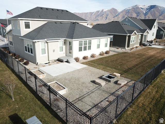 633 W Junegrass Ln, Stansbury Park, UT 84074 - rear view of house featuring a patio area, a mountain view, and a yard