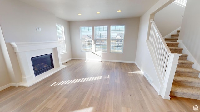 633 W Junegrass Ln, Stansbury Park, UT 84074 - unfurnished living room featuring light wood-type flooring