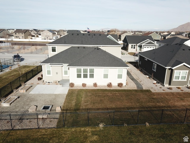 633 W Junegrass Ln, Stansbury Park, UT 84074 - rear view of house featuring a lawn
