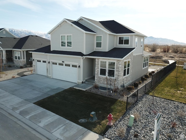 633 W Junegrass Ln, Stansbury Park, UT 84074 - view of front of property with a mountain view and a garage