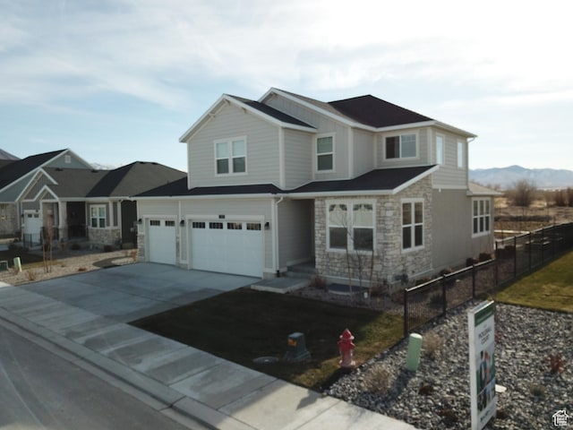633 W Junegrass Ln, Stansbury Park, UT 84074 - view of front facade featuring a mountain view and a garage