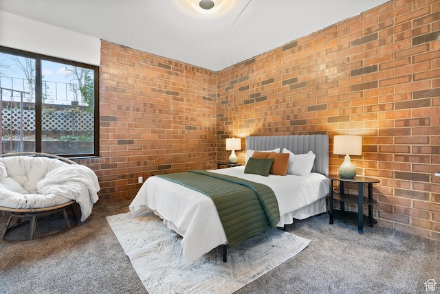 carpeted bedroom featuring brick wall