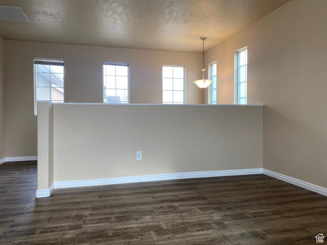 1036 N Darcy Dr W, North Salt Lake, UT 84054 - unfurnished room with a textured ceiling, dark hardwood / wood-style flooring, and plenty of natural light