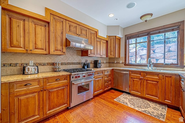 4129 Fairway Ln Unit A-3, Park City, UT 84098 - kitchen with sink, light stone counters, decorative backsplash, appliances with stainless steel finishes, and light wood-type flooring