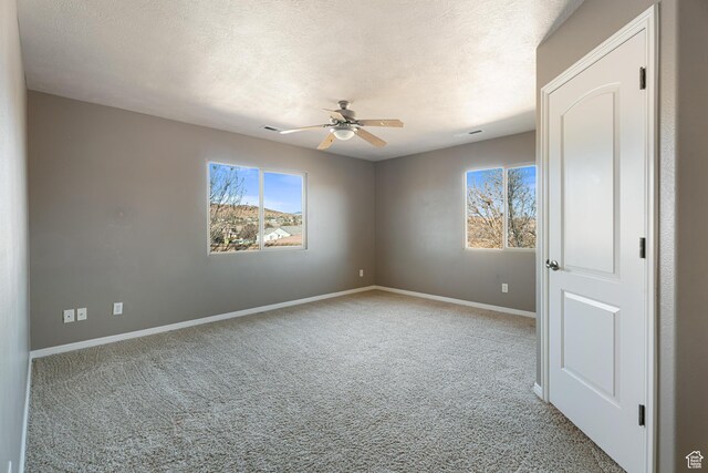 2371 E 2830 S, St George, UT 84790 - spare room featuring a textured ceiling, ceiling fan, and light carpet