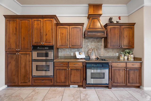 2371 E 2830 S, St George, UT 84790 - kitchen featuring backsplash, premium range hood, stainless steel double oven, light tile patterned floors, and dark stone countertops
