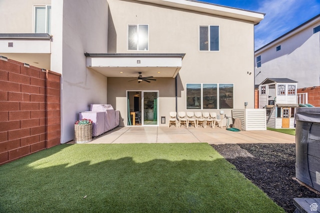 back of property with ceiling fan and a patio