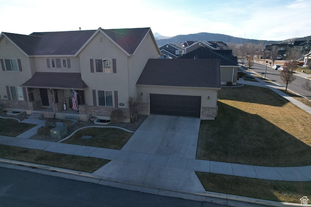 3318 E Quarter Mile Dr, Eagle Mountain, UT 84005 - traditional-style house with a garage, brick siding, driveway, stucco siding, and a front lawn